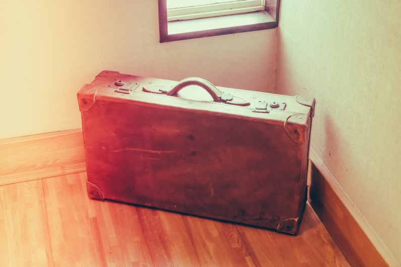 Photo of a brown vintage suitcase.