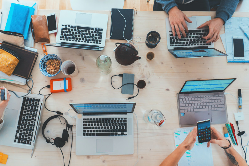 Laptops on a shared desk 