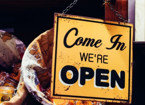 Photo of sign saying 'Come in, we're open'.